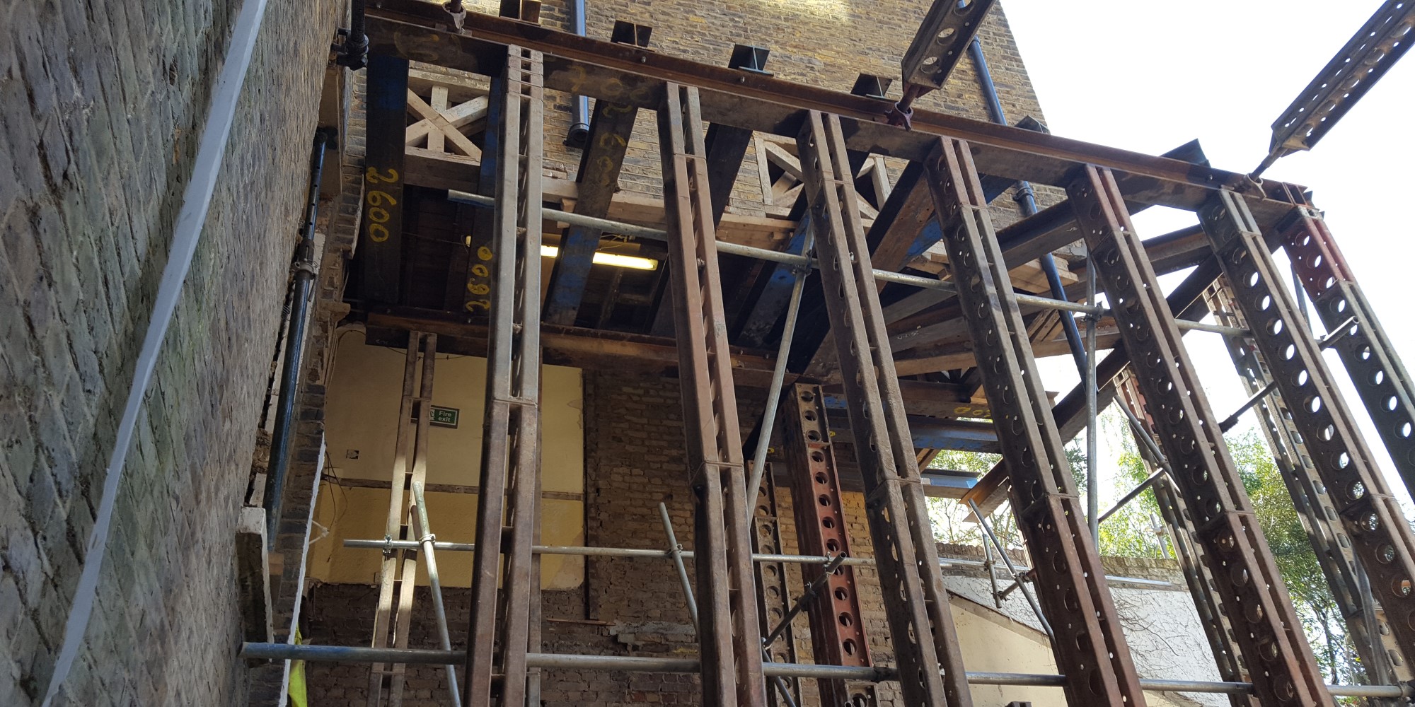 masonry building with brick facade, wooden floors and timber roof structure
